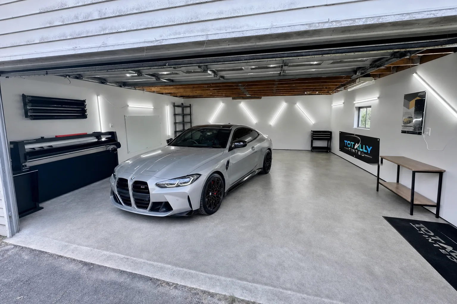 Liquid silver BMW M4 coupe with freshly tinted windows in the Totally Tinted garage studio