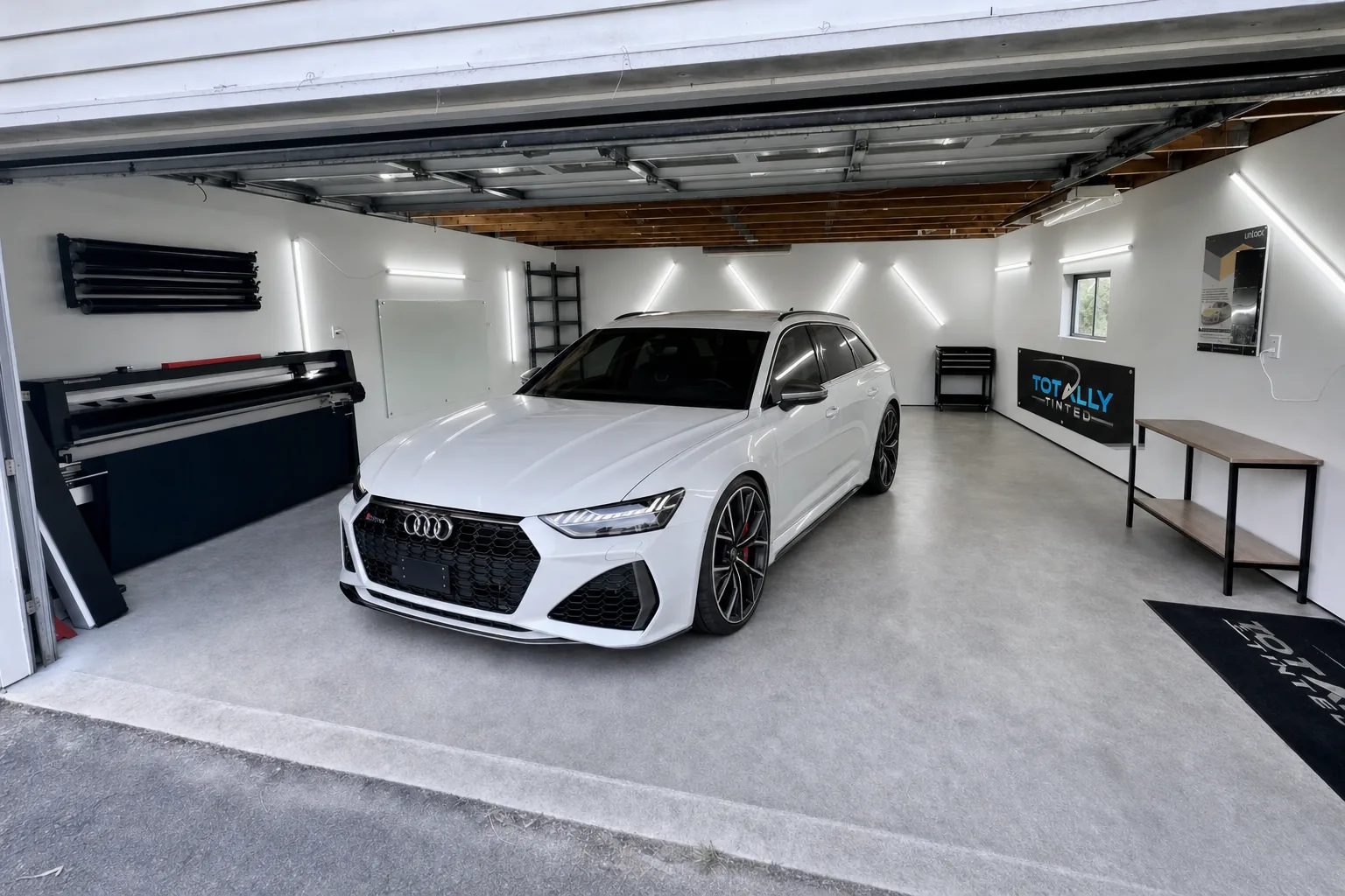 Pearl white Audi RS6 Avant with freshly tinted windows in the Totally Tinted garage studio