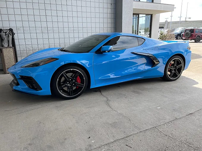 The same blue Corvette from the side, its tint finished