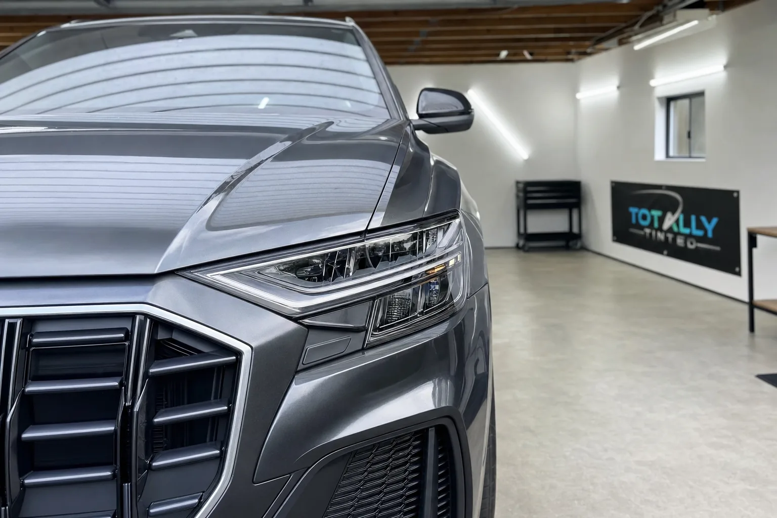 Graphite grey Audi Q8 with freshly tinted windows in the Totally Tinted garage studio
