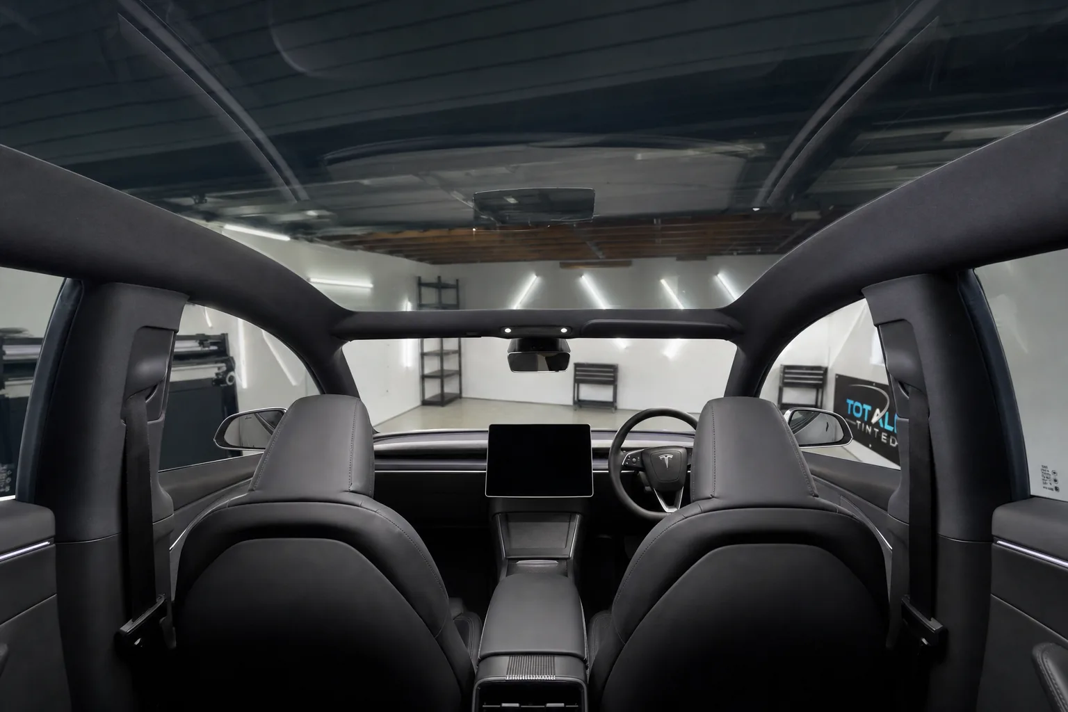Inside a Tesla under its tinted glass roof